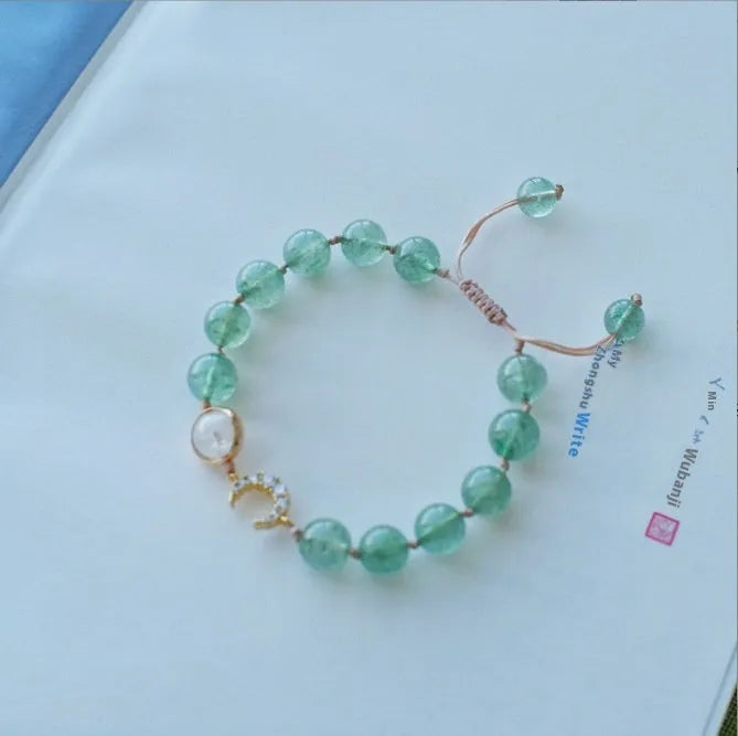 Handmade women's bracelet with strawberry quartz beads and Hetian jade peach blossom details.