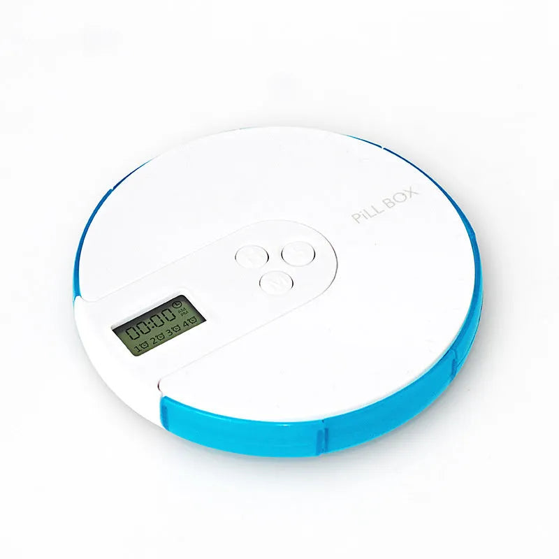 Blue seven-compartment alarm clock pill dispenser with digital display, shown next to pills.