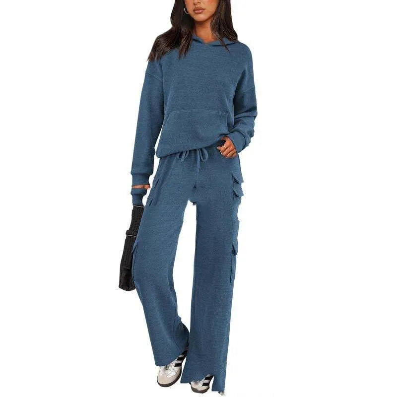 Women's black polyester leisure sports suit set with long sleeves and trousers laid flat.