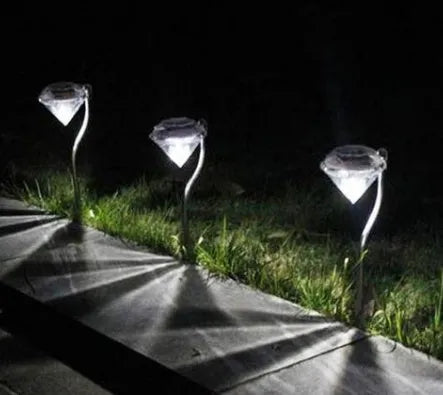 White solar-powered diamond-shaped garden spotlight with adjustable head on a stake.