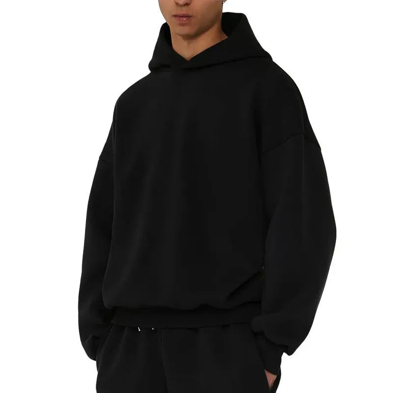 Man wearing a solid colour fleece-lined cotton hoodie sweater with a wool lining.