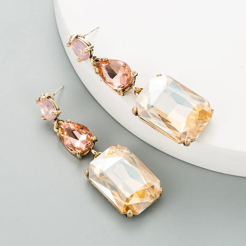 Pair of minimalist rhinestone geometric earrings in round shape, available in purple, green, or brown, European American fashion style.
