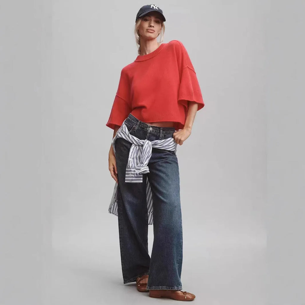 Red short sleeve viscose crop top with an exposed navel design on a model.
