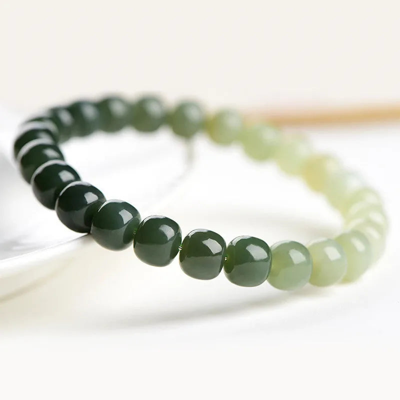 Hetian jade bracelet with clear water gradient beads on wrist.