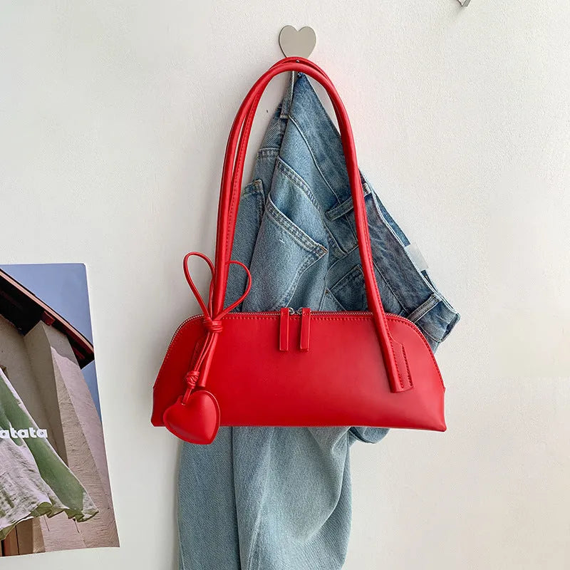 Crossbody shoulder bag in black PU with double straps, horizontal square shape, and visible sewing thread detail on front