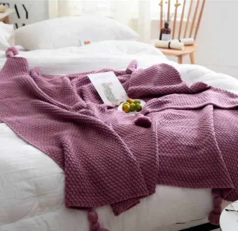 Nordic-style fringed knit acrylic blanket in a neutral colour, laid flat showing its 130x170cm size.