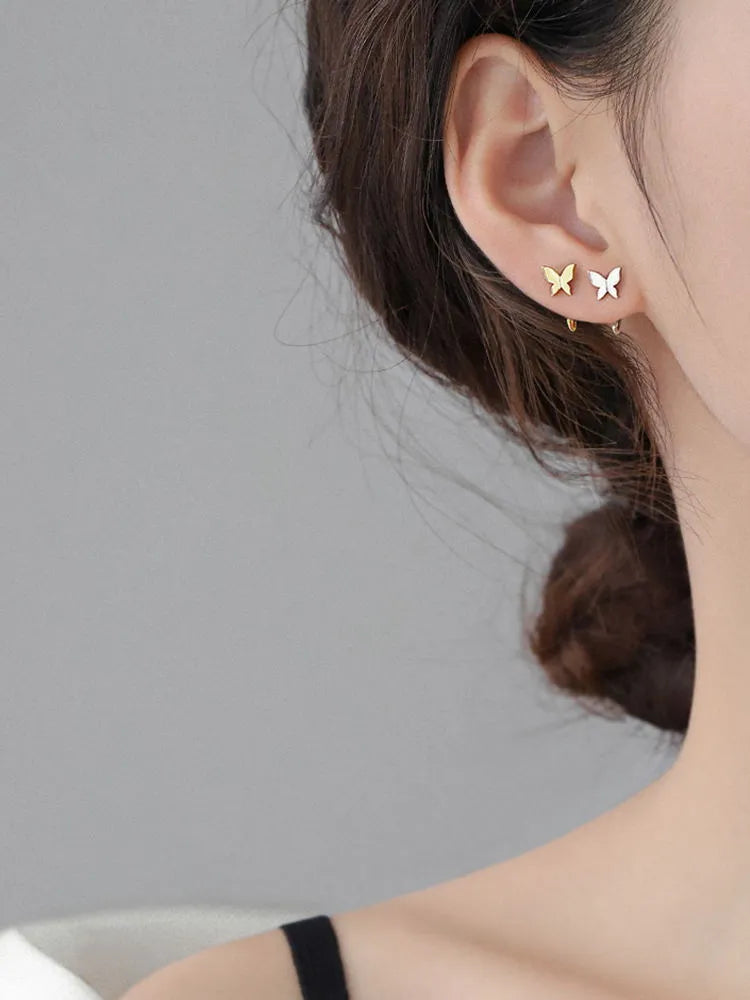 Pair of 925 silver butterfly stud earrings, 13x6mm, golden colour finish on grey background