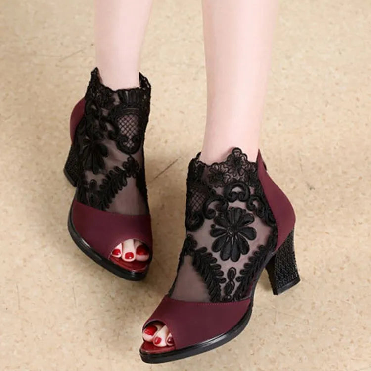 Women's black lace gladiator sandals with square high heel and zip closure, showing flower pattern detail