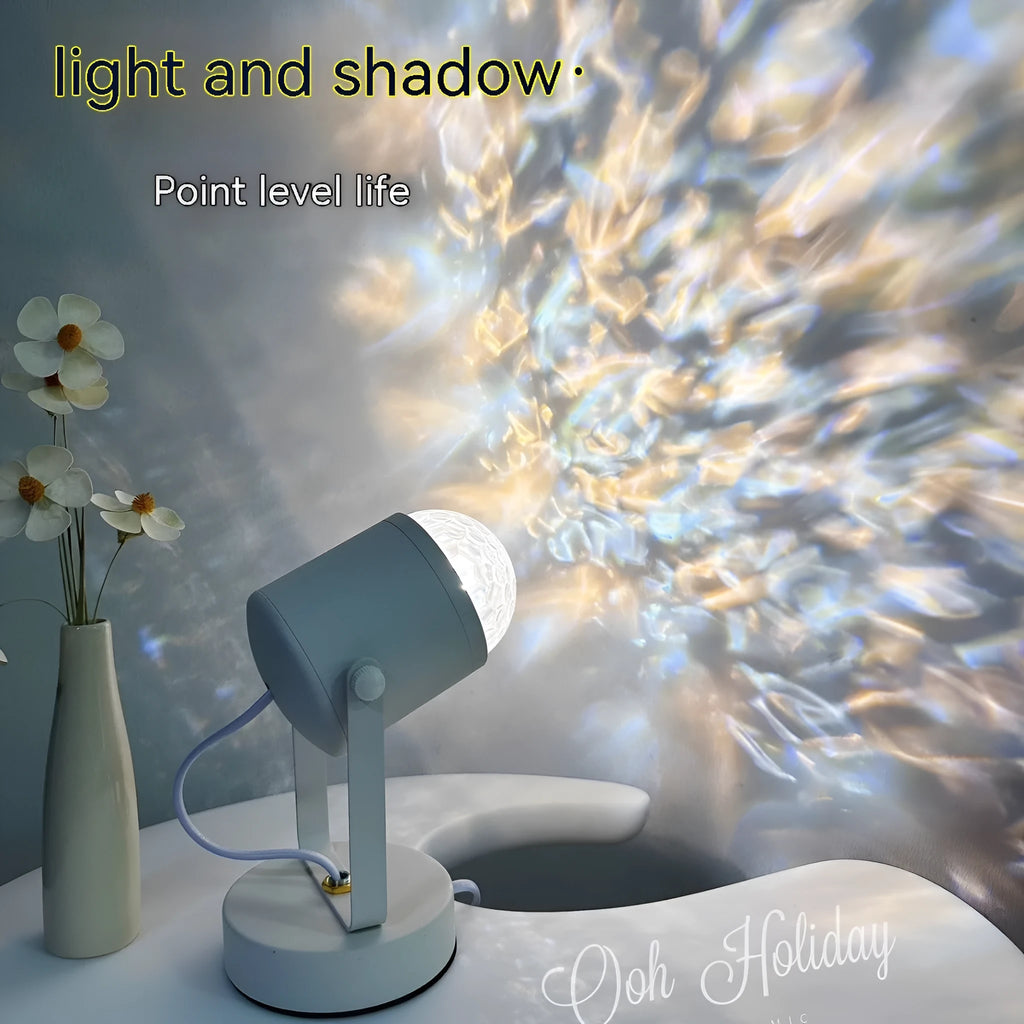Dynamic water ripple projection table lamp with metal holder on a desktop.