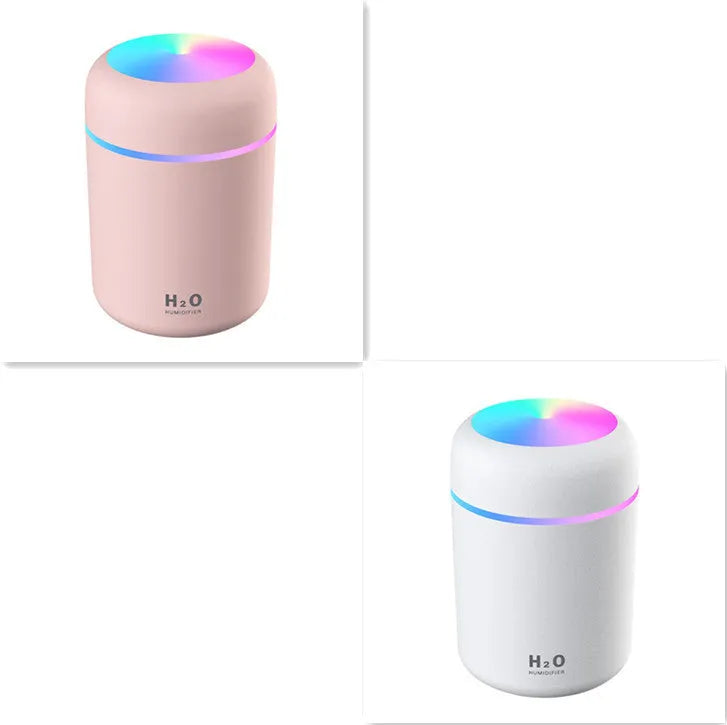 Pink USB desktop humidifier with colourful LED lights and 300ml water tank on wooden desk