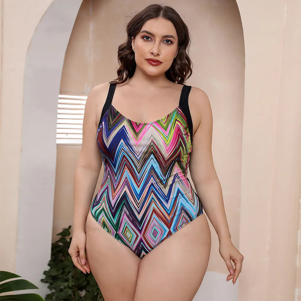 Floral print one-piece swimsuit with spaghetti straps and a conservative vest-style top.