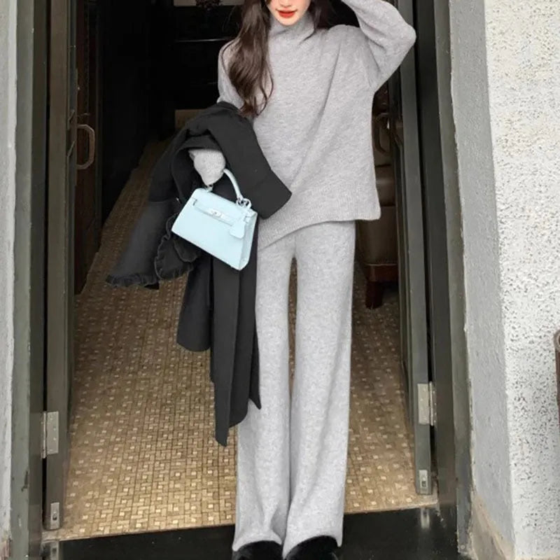 Women's casual two-piece set showing sweater and wide leg trousers in solid colour with thread detail