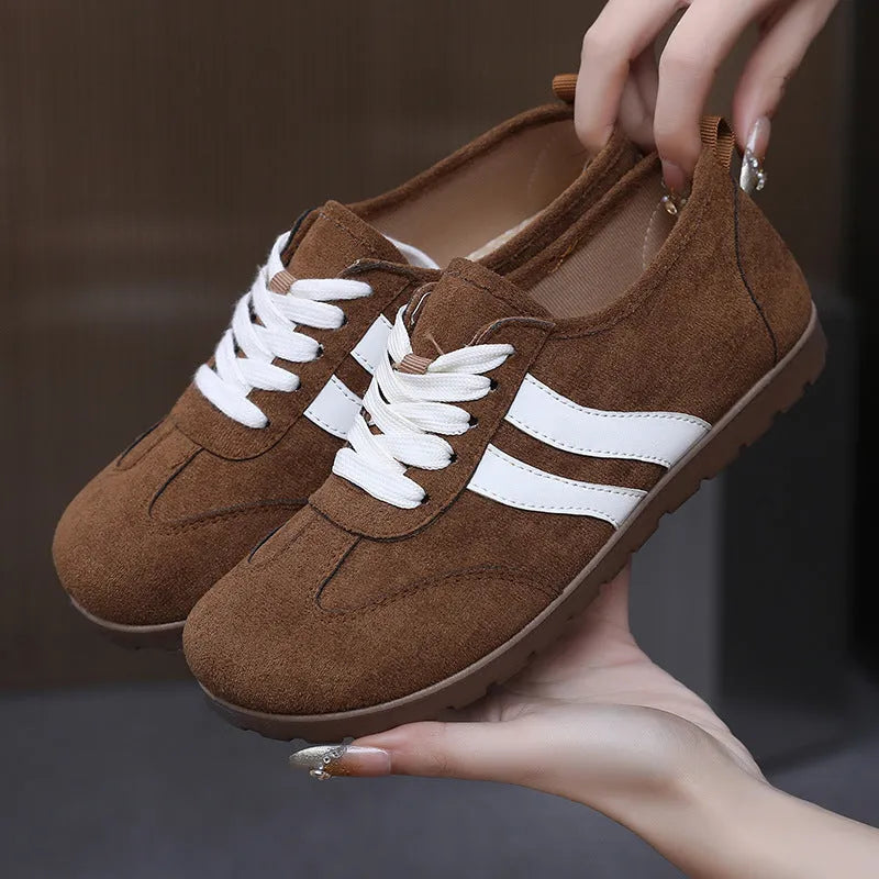 Women's vintage canvas sneakers in dark red with a soft rubber sole and round toe.