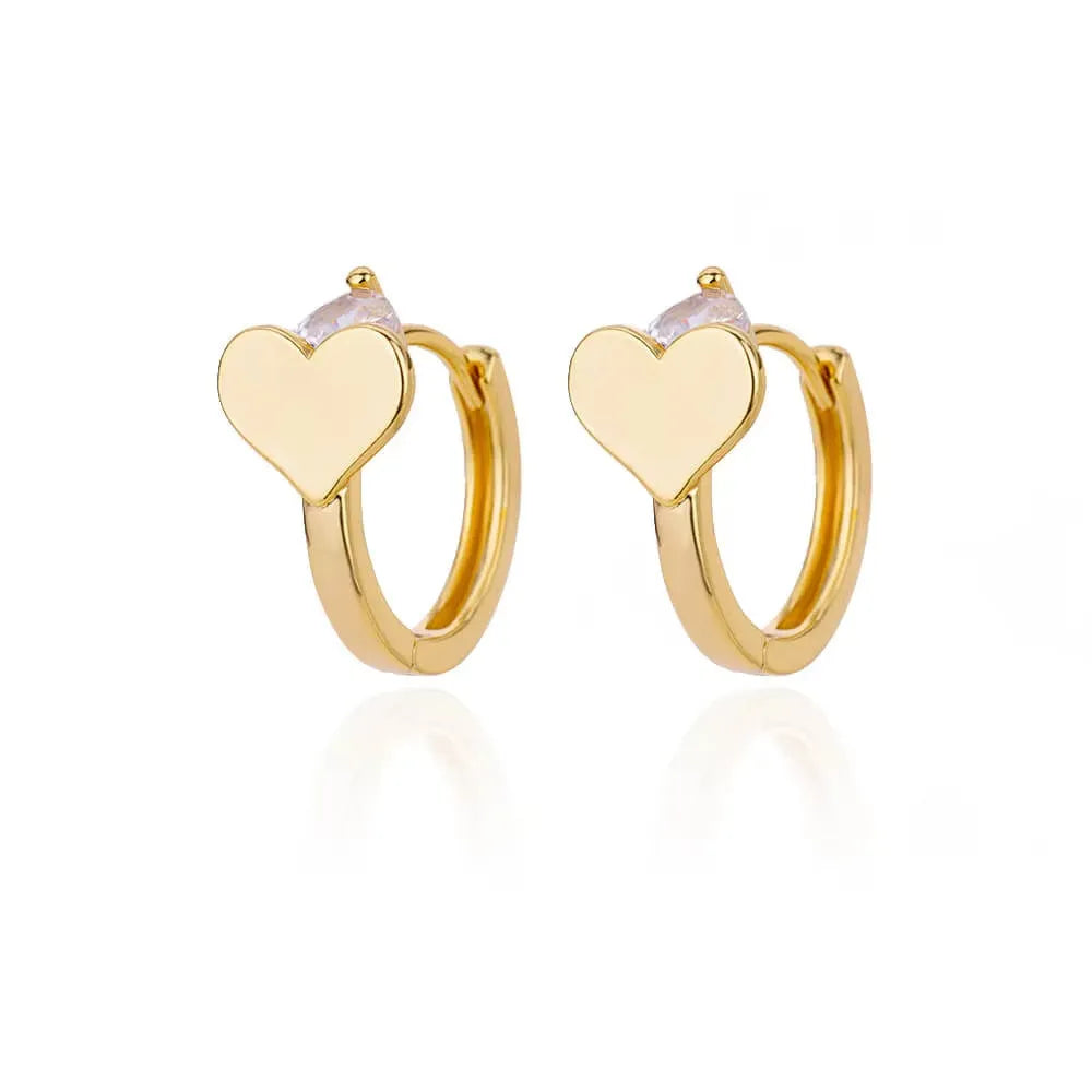 Simple silver-tone heart-shaped stud earrings with zircon stones on a white background