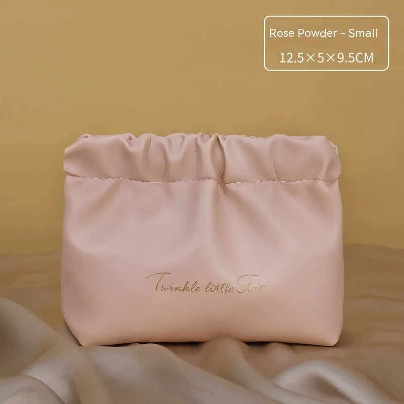 Large leather travel toiletry bag open to show dry and wet separation compartments.