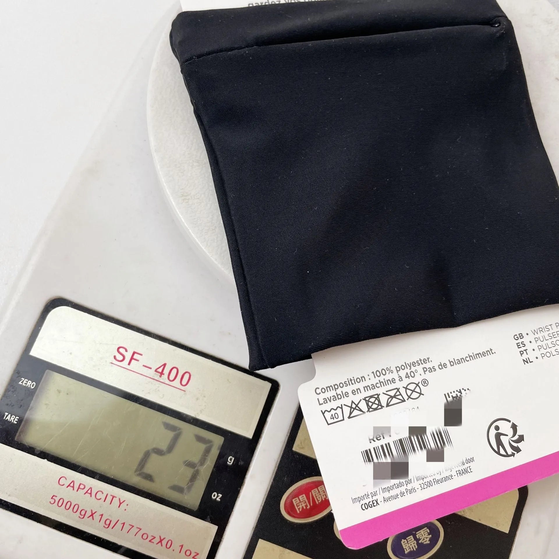 Black wrist bag armband sleeve for mobile phone storage, shown on a wrist.