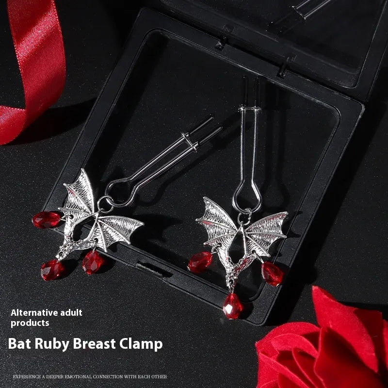 Silver alloy bat nipple clamp with ruby design showing adjustable pressure mechanism
