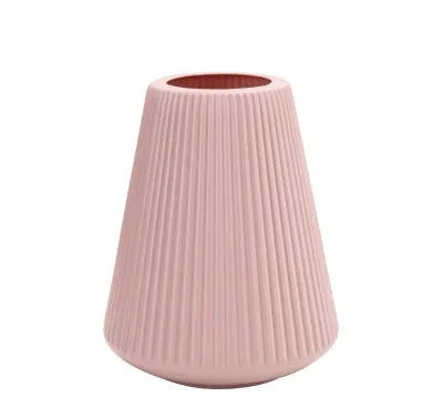 White melamine plastic decorative flower vase measuring 16cm by 20cm on a desktop