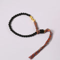 Hand-woven obsidian carrying strap bracelet showing textured weave detail and narrow 4mm width