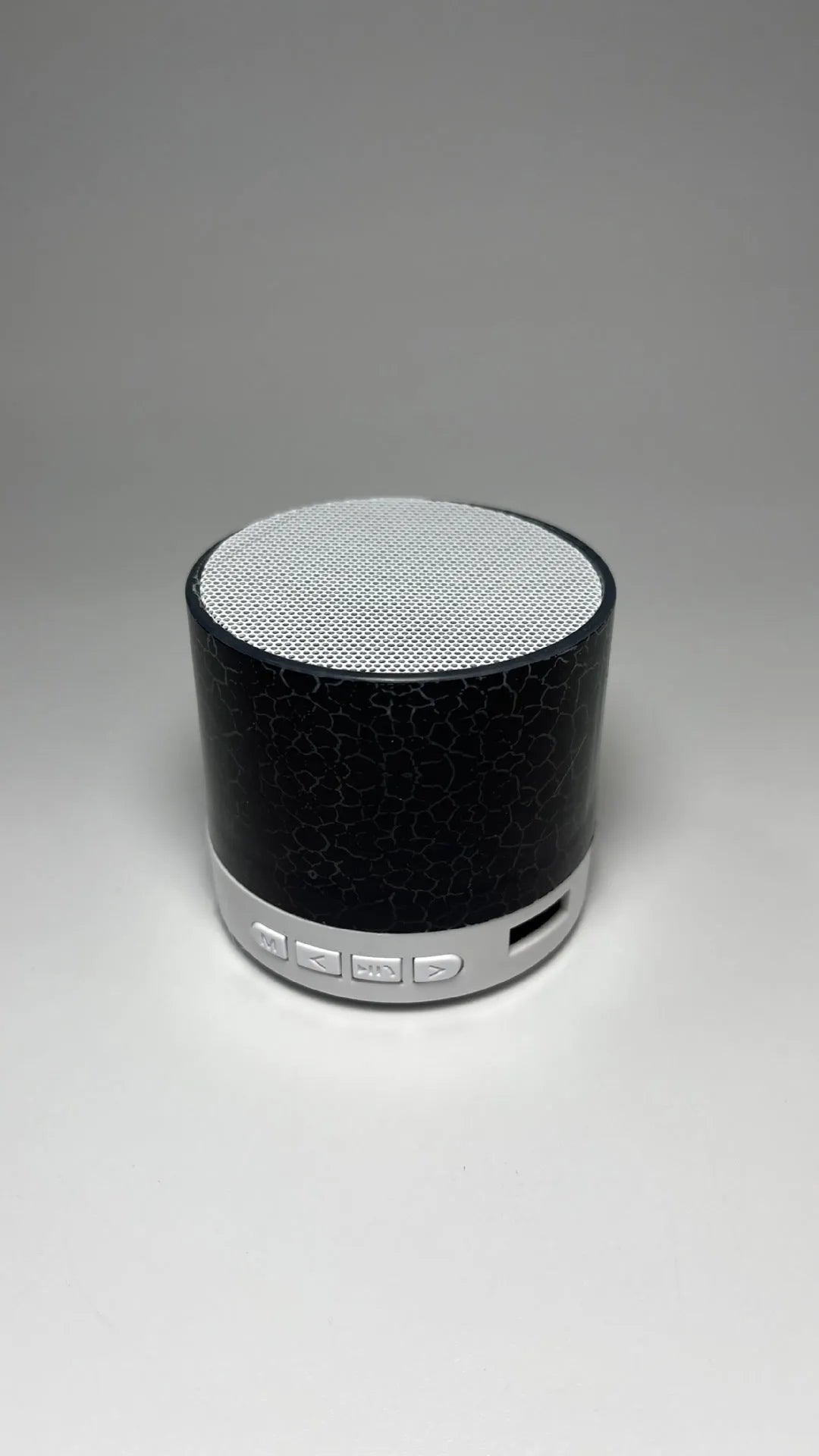 A9 Mini Cracked Bluetooth Speaker in blue with LED lights on a table