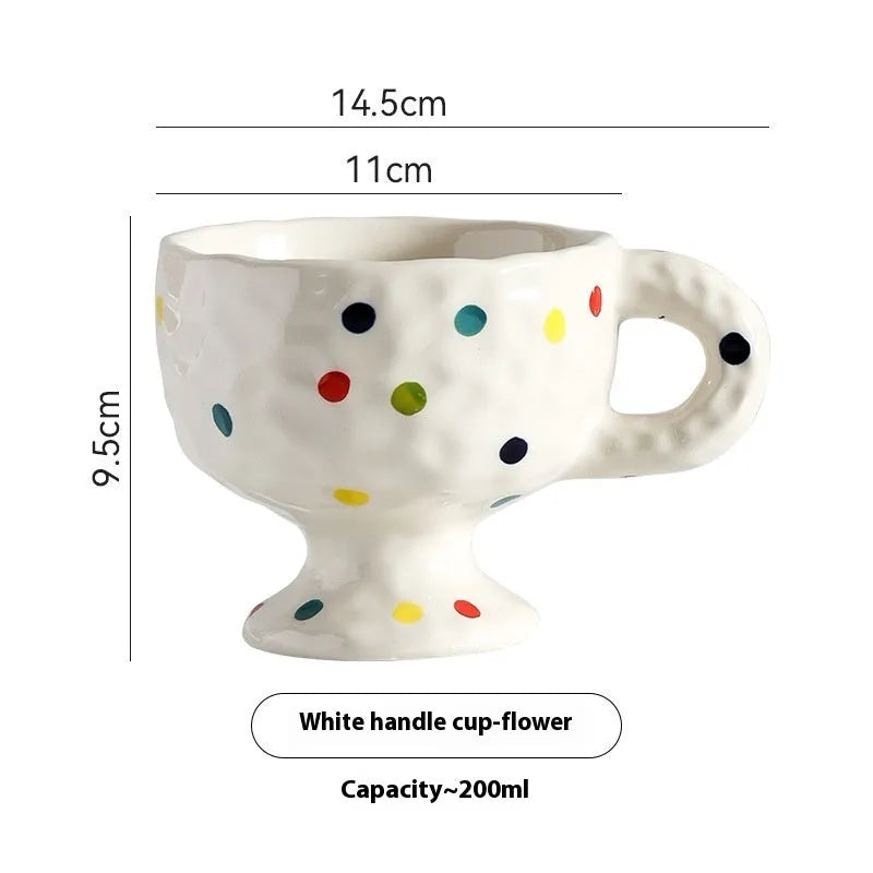 Hand-pinched irregular ceramic mug in solid colour with modern design