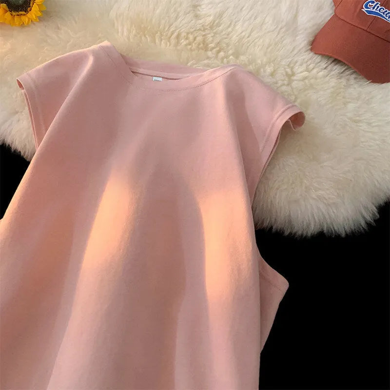 Men's loose-fitting solid colour cotton tank top on a hanger, shown in a light colour.