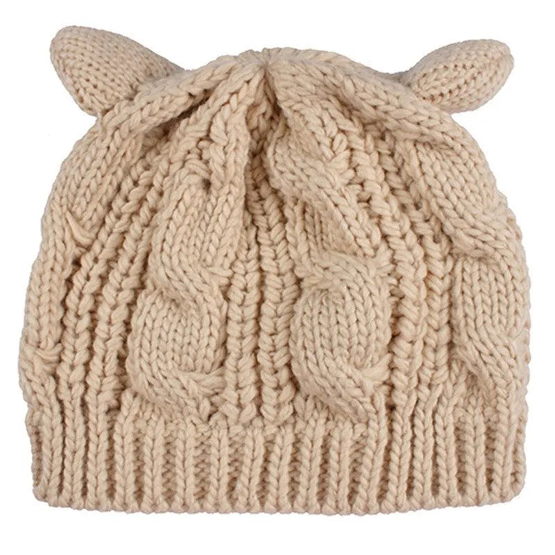 Hand made 3D knitted cat ear beanie in wool, shown in multiple colour options including red, black and beige.