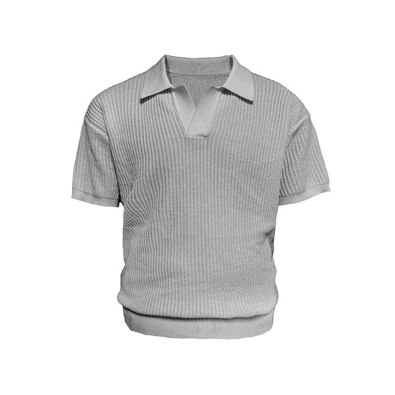Man wearing a creamy-white loose fit short-sleeved polo shirt with a striped collar.