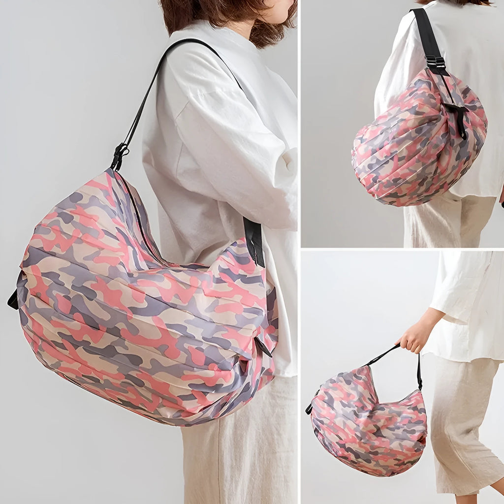 Foldable large-capacity shopping bag in 210d Oxford cloth with pink camouflage colour, hanging on a wall hook