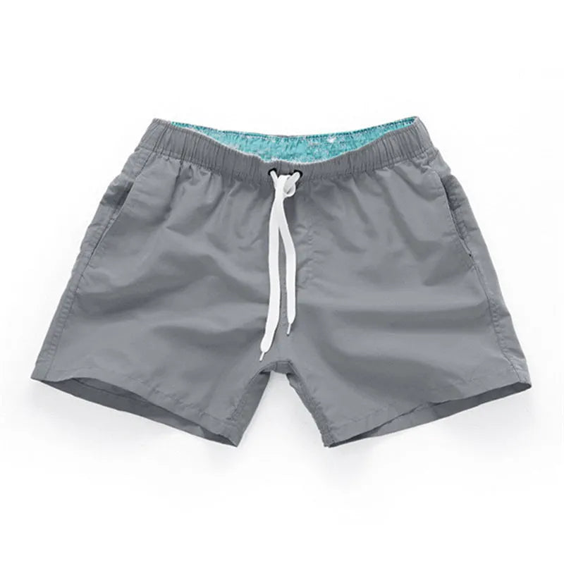 Men's straight leg polyester board shorts on a hanger, available in multiple colours and plus sizes.