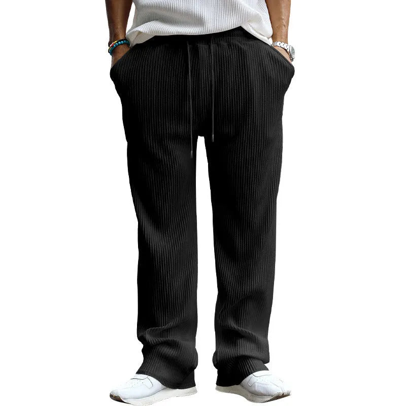 Man wearing loose high-waist striped casual trousers in Army Green, showing the straight leg fit.