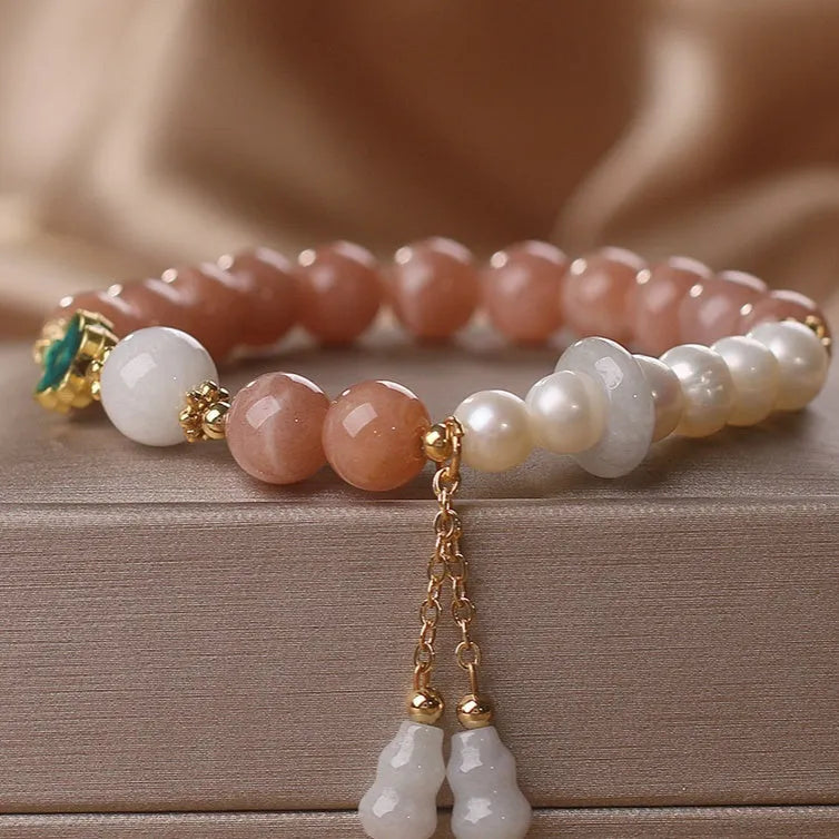 Natural sunstone bracelet with orange sunstone jade calabash pendant and moonstone beads on display
