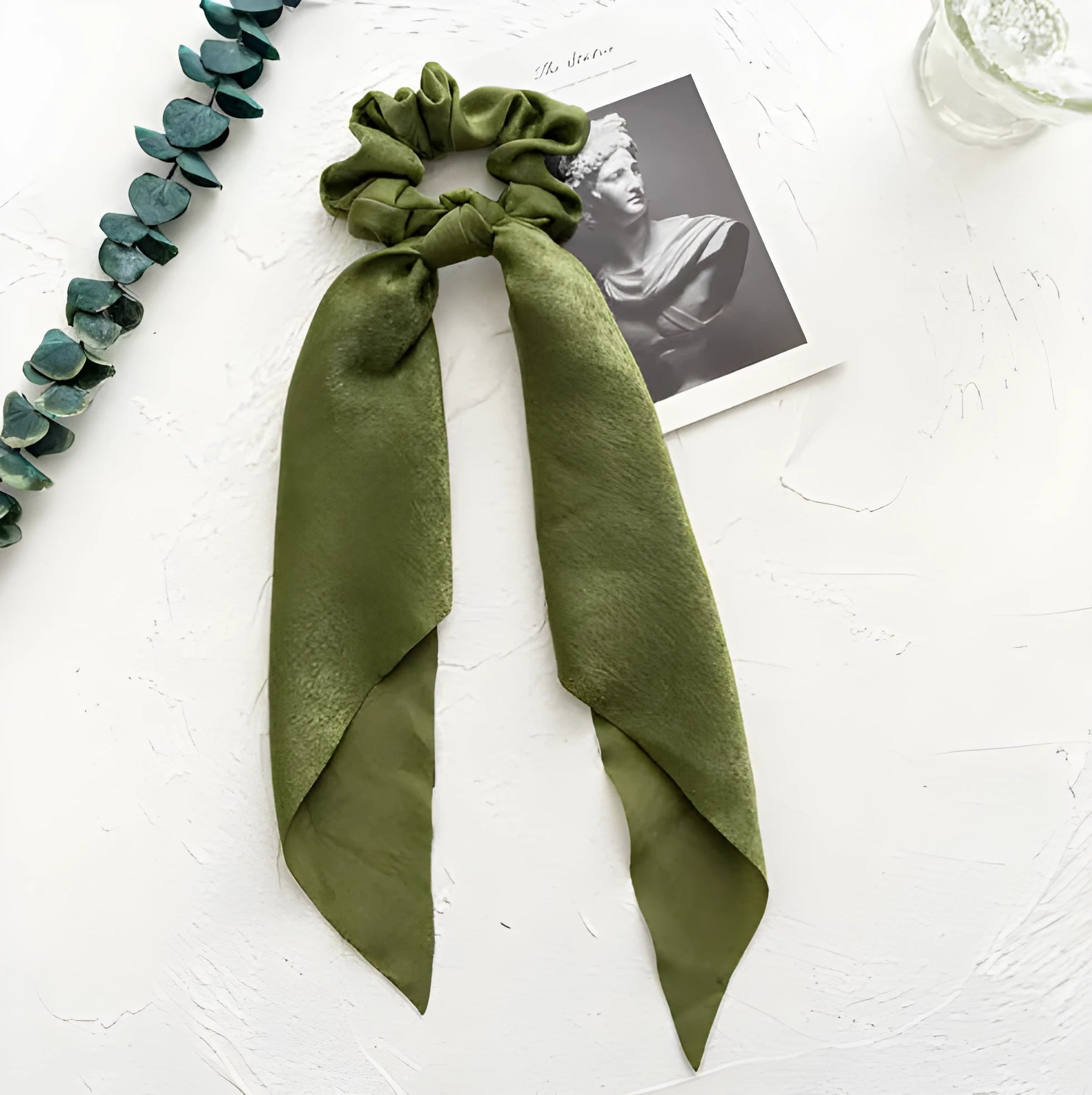Long dark green floral cloth ribbon hair tie with a large metal ring closure for ponytails.