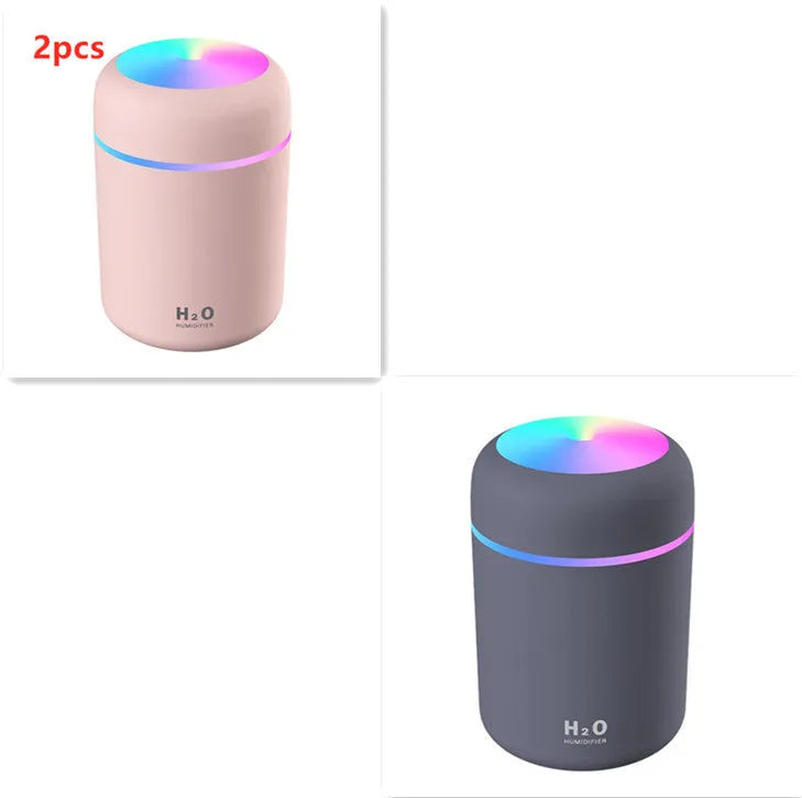 Pink USB desktop humidifier with colourful LED lights and 300ml water tank on wooden desk