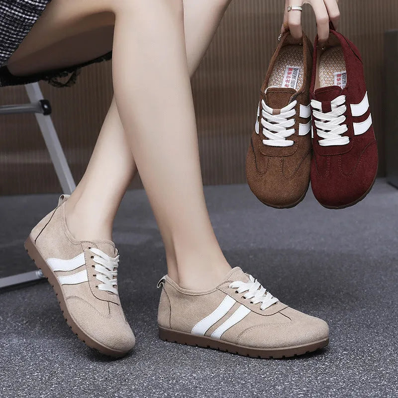 Women's vintage canvas sneakers in dark red with a soft rubber sole and round toe.
