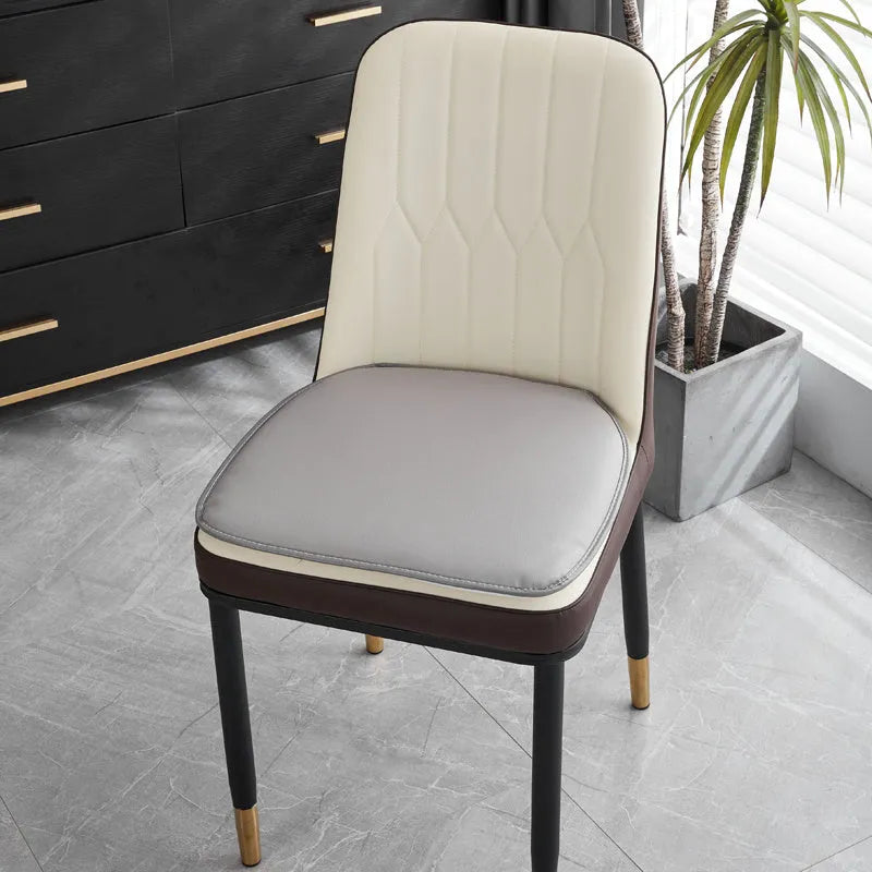 Leather horseshoe-shaped seat cushion in beige colour showing curved design and non-slip underside