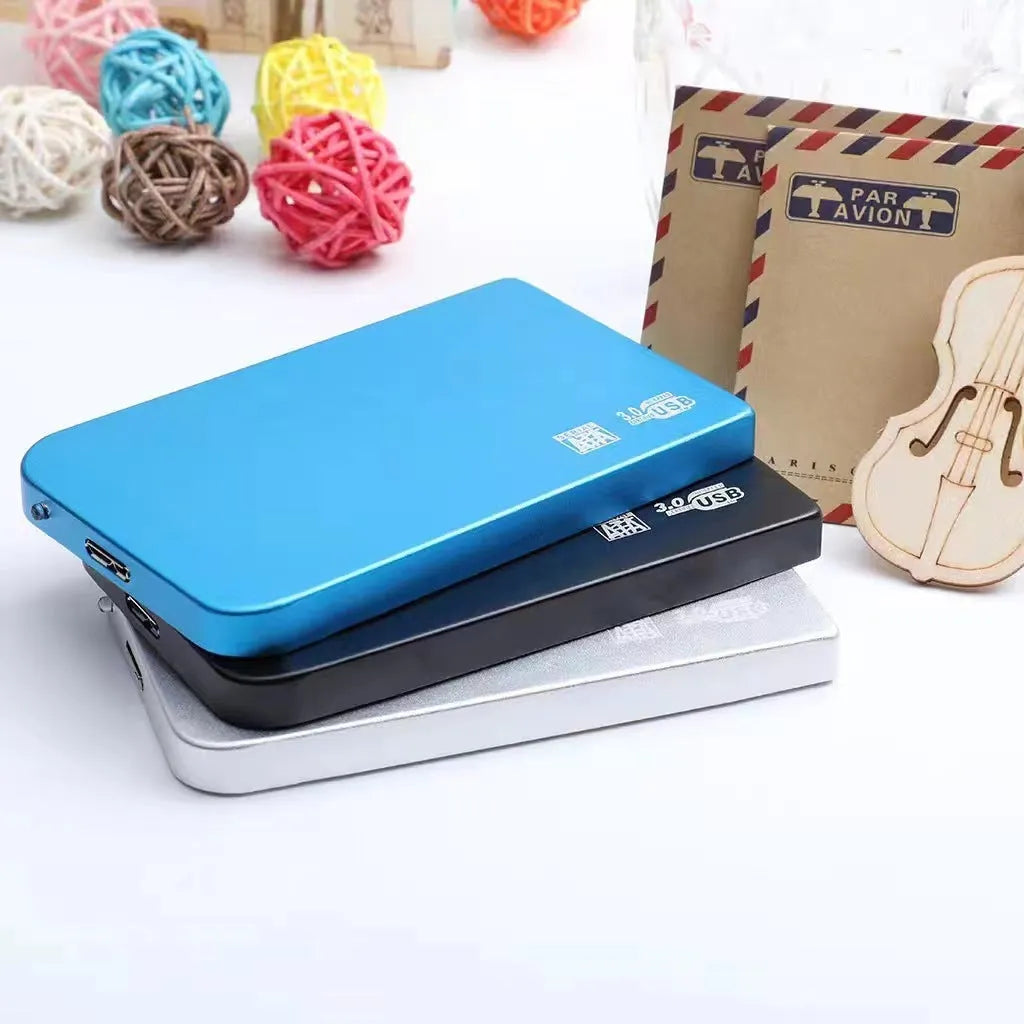 Silver metal external solid state drive with USB 3.0 cable on a desk.
