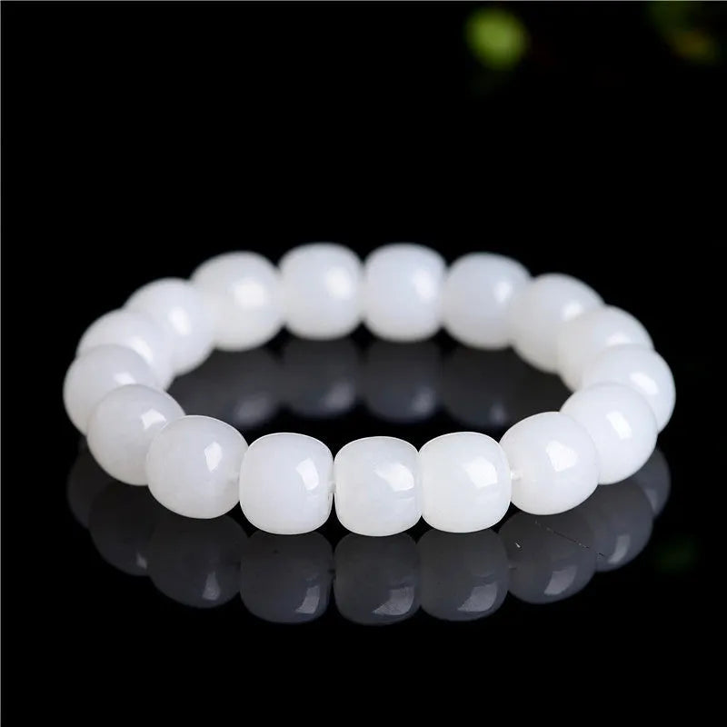 White Hetian jade barrel bead bracelet shown in three bead size variations on a wrist.