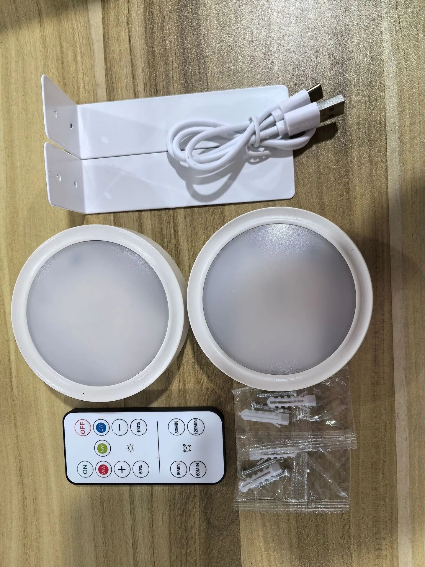 Wireless LED painting lamp with a magnetic mounting belt and remote control in black finish.