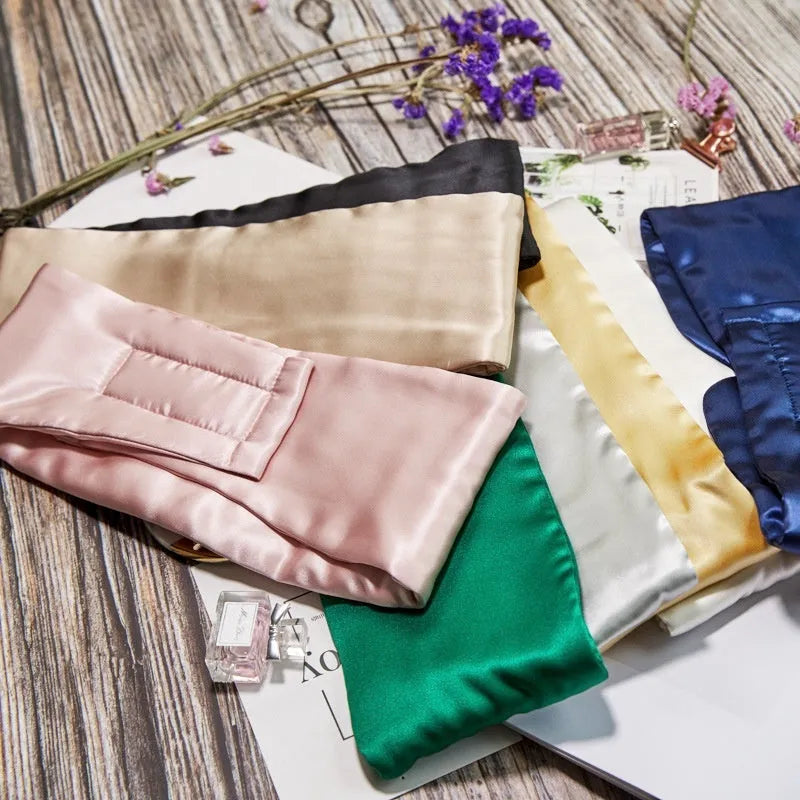 Mulberry silk sleep eye mask shown in champagne gold colour, laid flat on a surface.