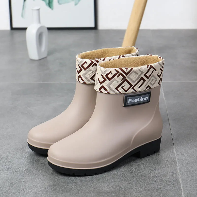 Women's mid-calf PVC rain boots in black with low heel design