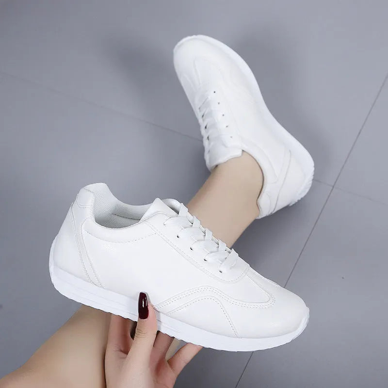 Women's white platform casual sneakers with thick sole, lace-up closure, and rubber outsole on a neutral background