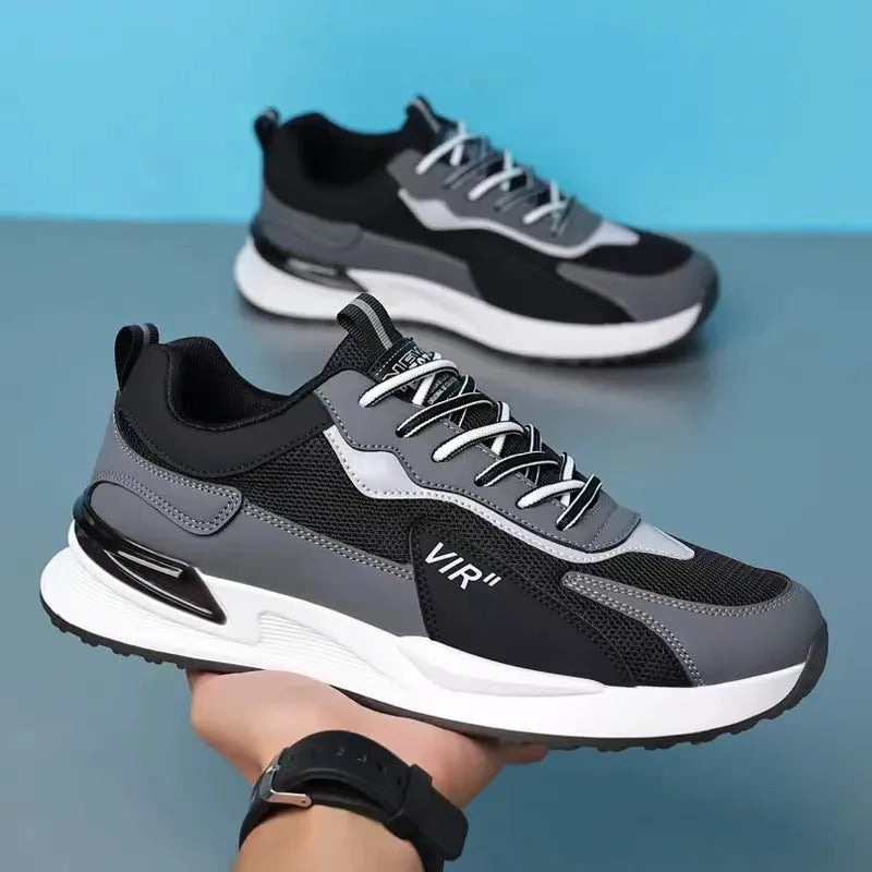Men's colour block mesh sneakers in black, grey, and white with round toe and flat heel.