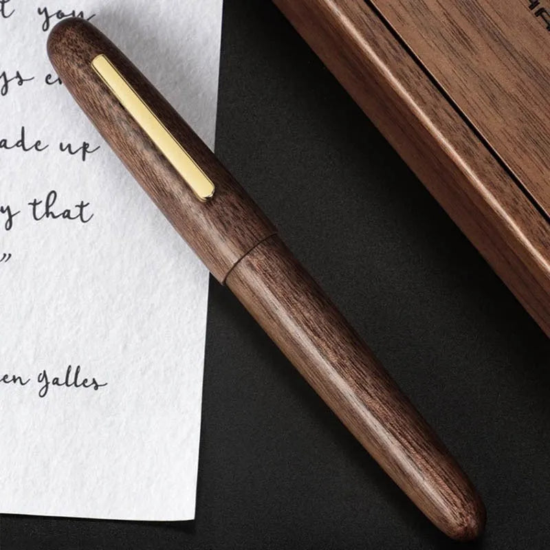 Wooden fountain pen with rotating cap shown in various wood finishes including rosewood and ebony.