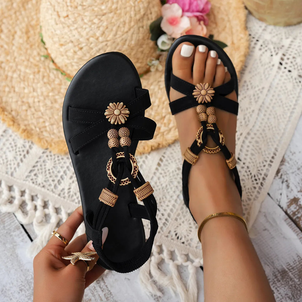Black ethnic style women's flat sandals with beaded weave and rhinestone decoration on a rubber sole.