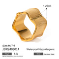 Close-up of a stainless steel ring with a wide geometric wave pattern and electroplated metallic finish.