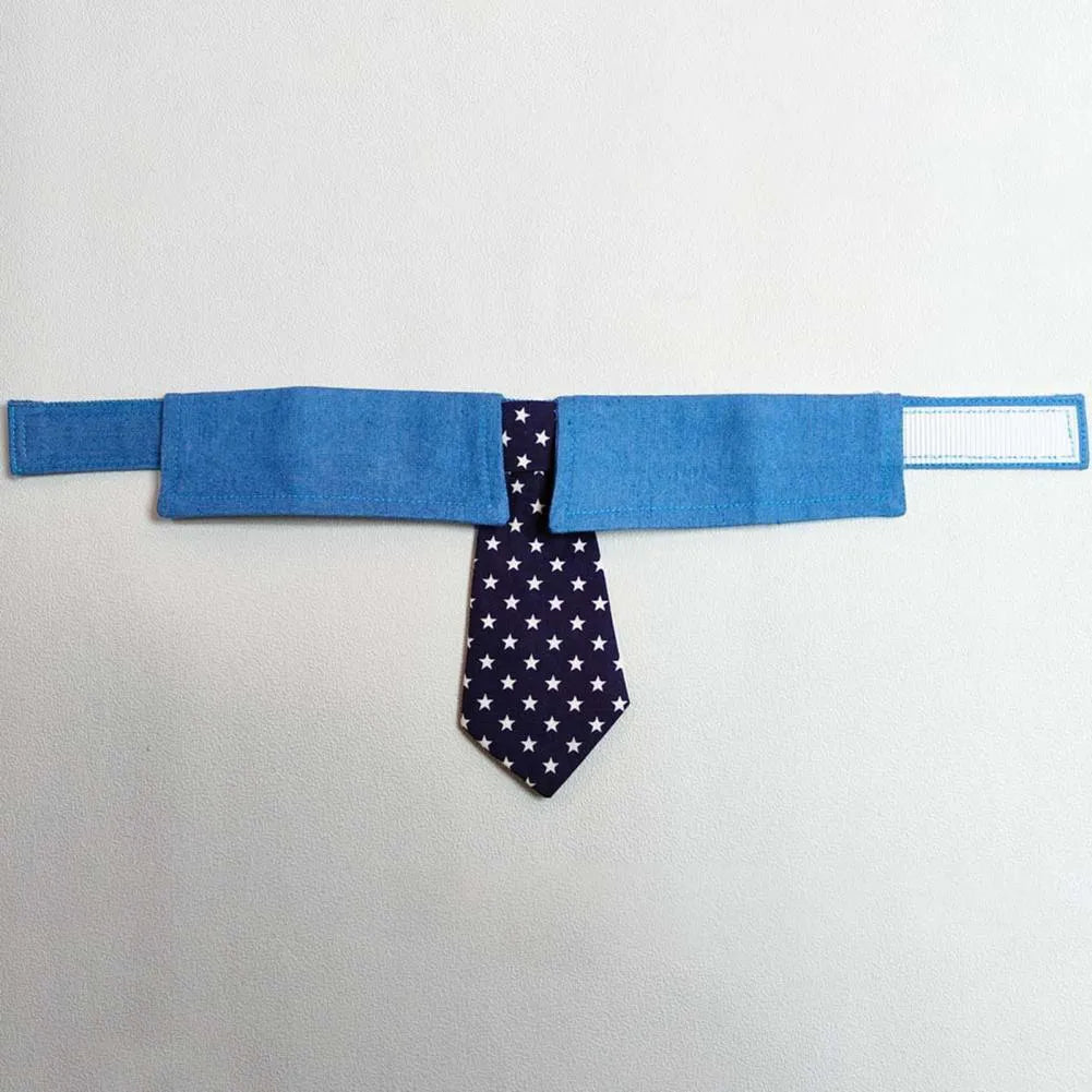 Blue denim dog collar with a star-pattern bow tie, shown with a fastener tape closure.