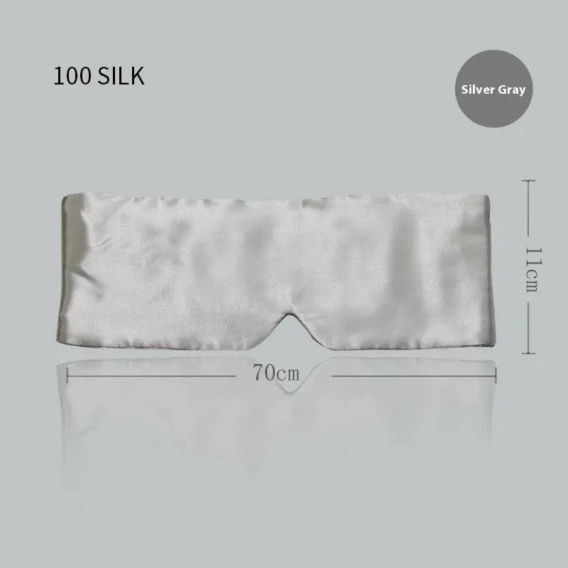 Mulberry silk sleep eye mask shown in champagne gold colour, laid flat on a surface.