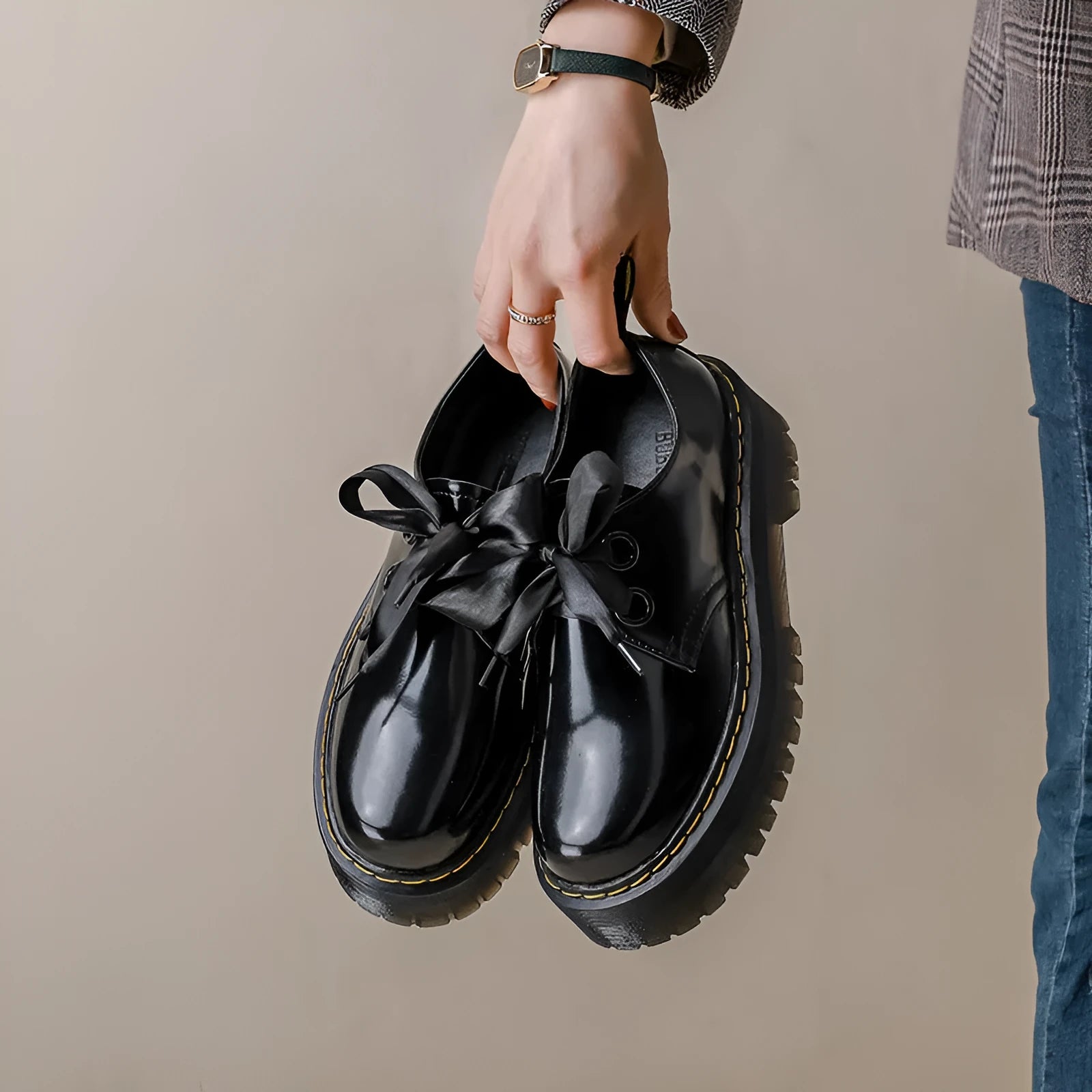 Women's black leather shoes with thick soles, ribbon cross straps, and lacing closure