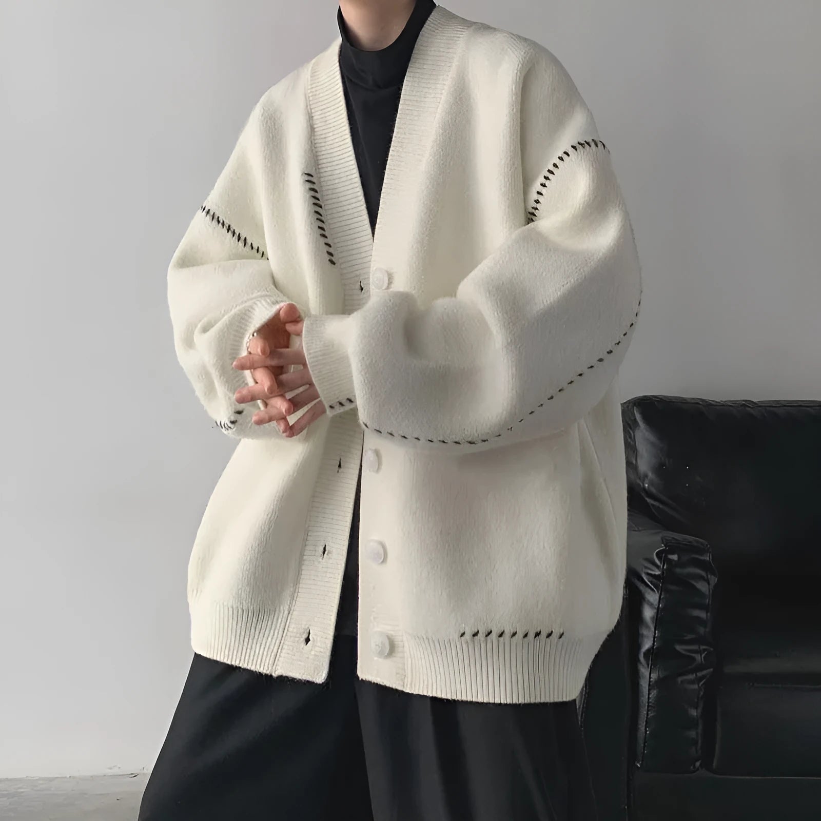 Women's knitted cardigan top coat in black or white with loose fit and long sleeves